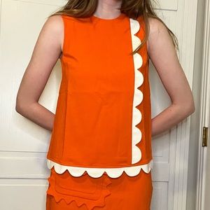 '60s-style orange top with white scalloped trim by Victoria Beckham